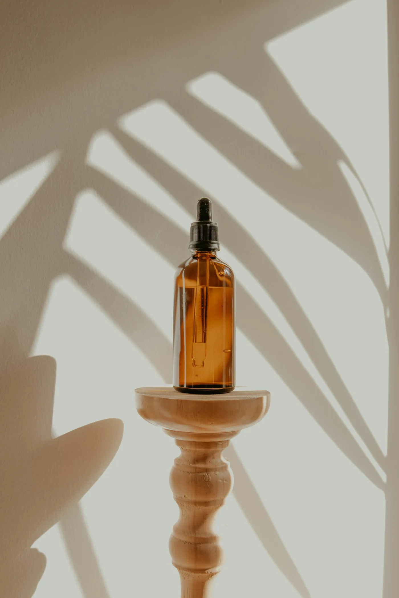 Amber dropper bottle lit by afternoon sunlight