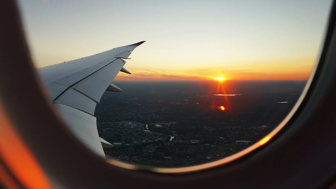 Airplane wing seen from a window at sunset